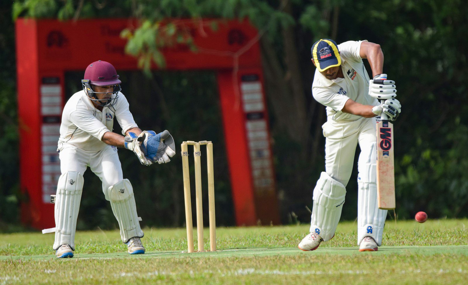 Cricket player with bat and cricket gear